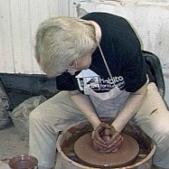 Communion Pottery photo of Debra Ocepek throwing a clay goblet on the potters wheel